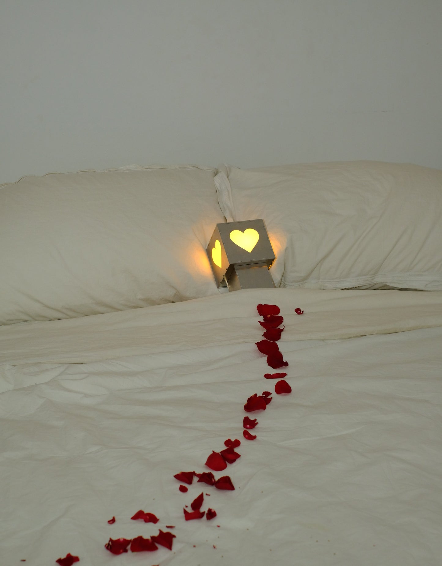 Heart lamp at the end of a trail of rose petals
